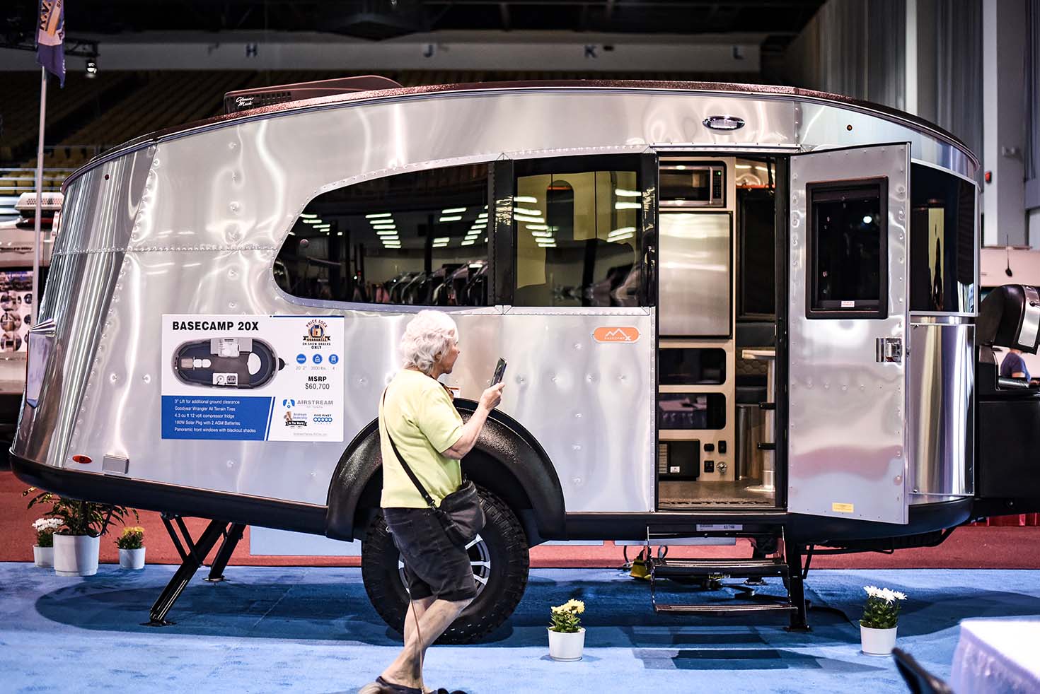 Monotone-interiors_3 | I Heart RVing Woman standing near chrome RV with open door