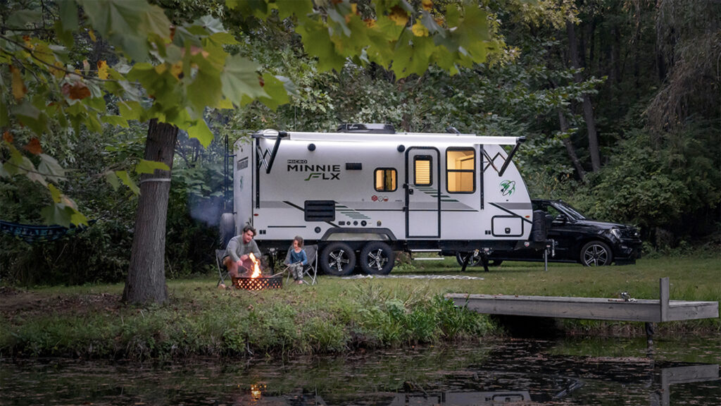 winnebago-featured-image copy | I Heart RVing Family outside Winnebago at campsite
