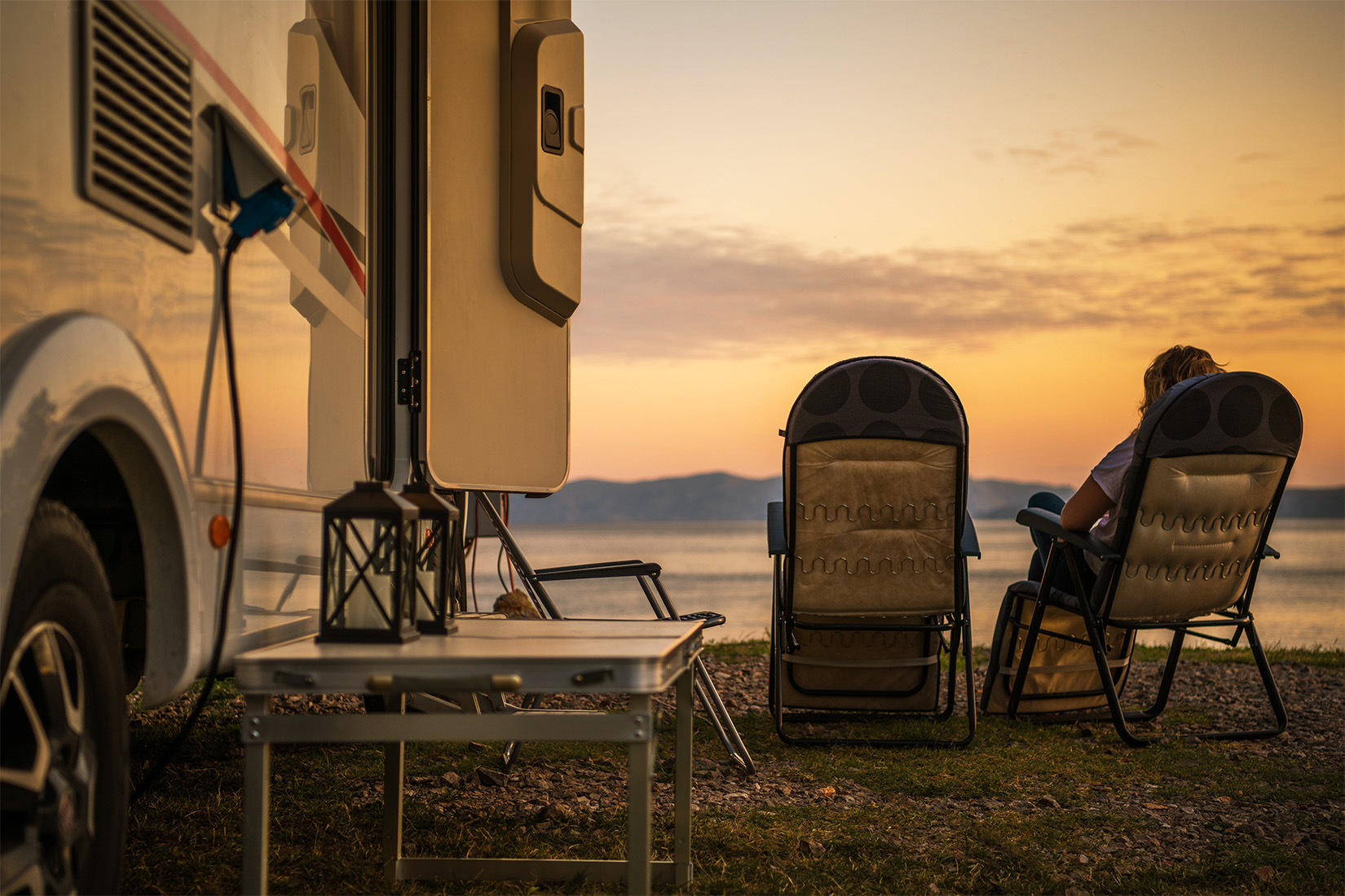 WhatYourRVSaysAboutYou-sunset-4 | I Heart RVing Two chairs outside near RV at sunset