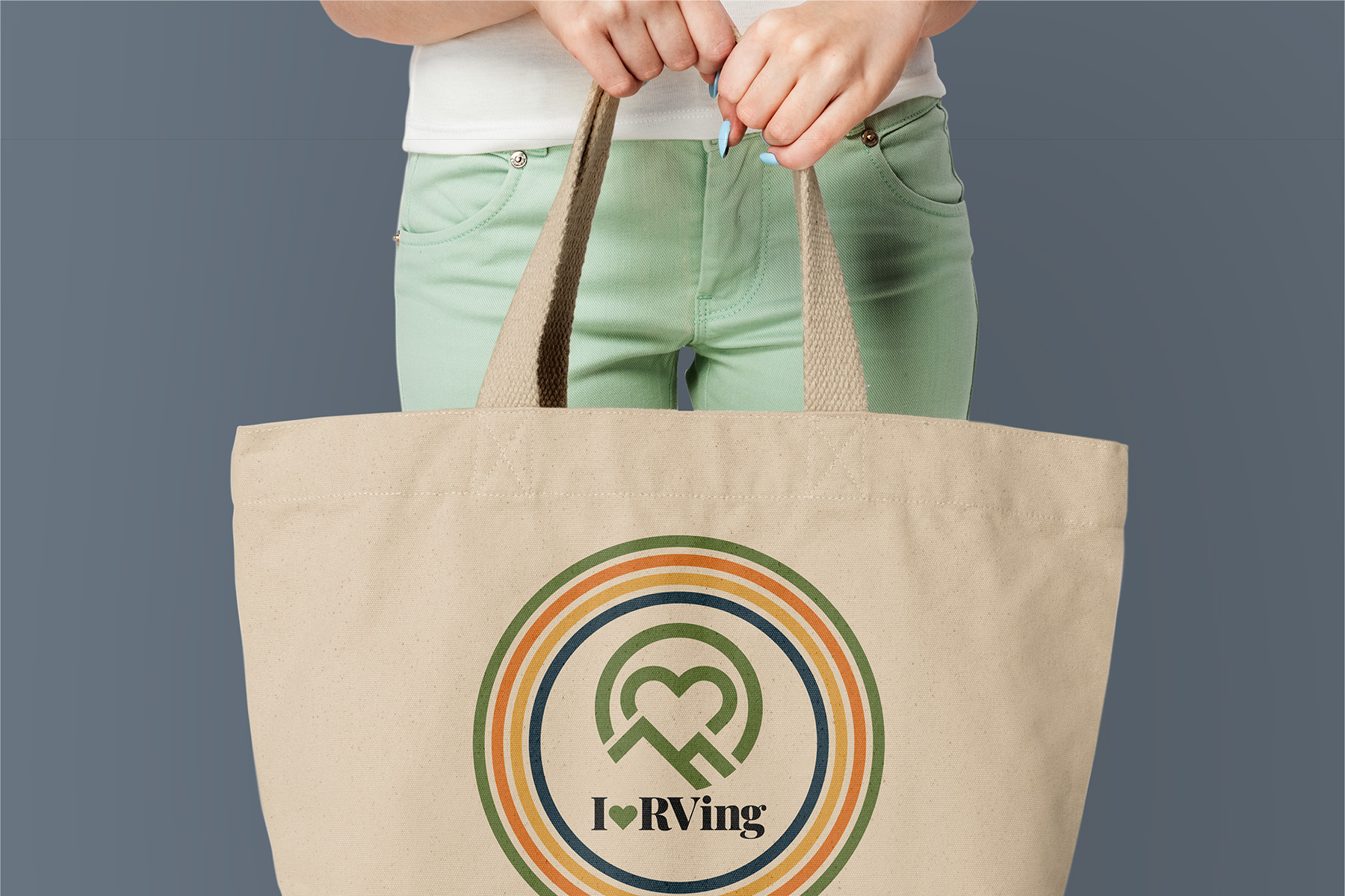 Woman holding beige I HeartRVing tote bag