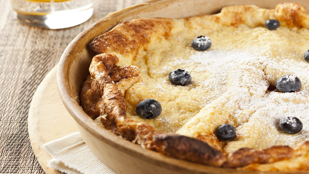 HomemadeGermanPancakeWithBlueberriesOnABackground | I Heart RVing Campfire Dutch Oven Recipes: German pancakes