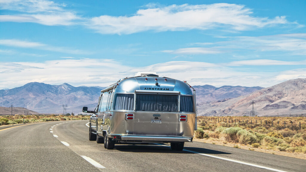 CaliforniaUsa05-01-2021-airstreamCamperOnTwoLanedHighwayDrivingThrough | I Heart RVing Airstream travel trailer