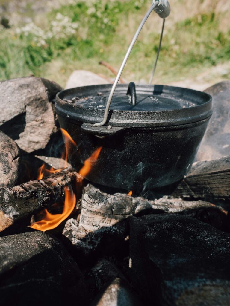 paulina-herpel-3h1EDpka0VY-unsplash | I Heart RVing Making popcorn in a cast-iron skillet over a fire